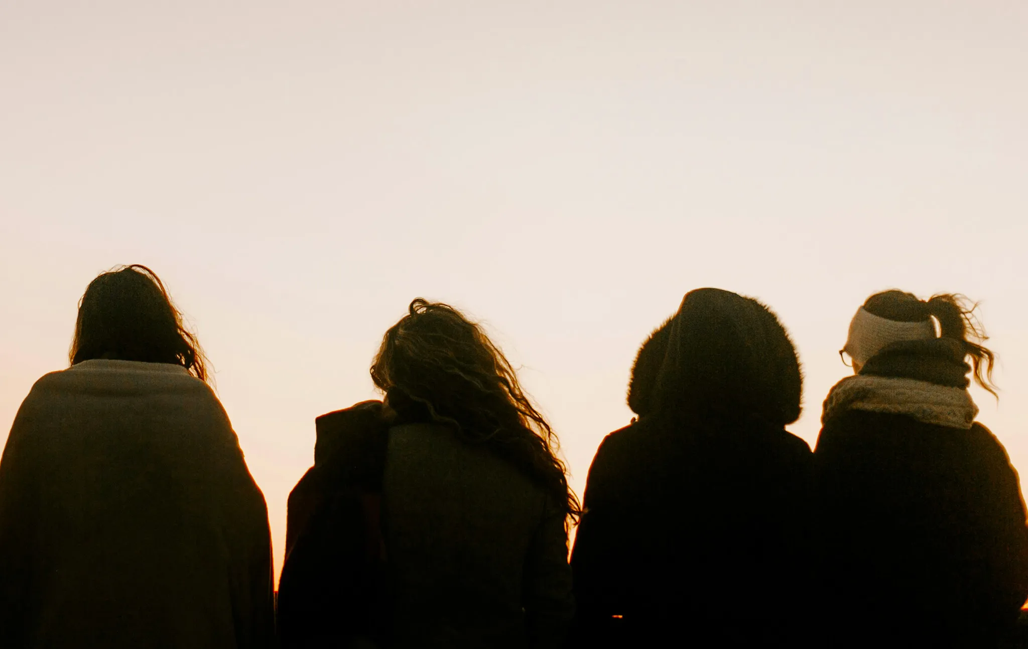 A group of mothers photographed from behind